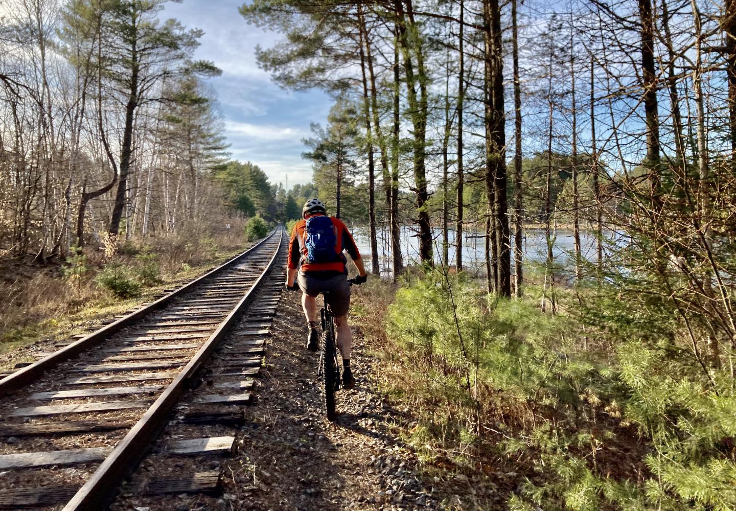 A cyclist pedals along a Saranac Lake section of the Adirondack Rail Trail prior to the rails being removed.