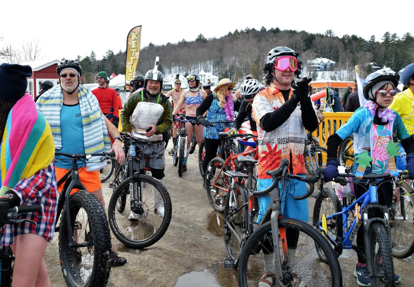 Participants in the Blue Buns Wheel-a-Palooza line up at the Ice Palace for a Saranac Lake Winter Carnival slow roll.