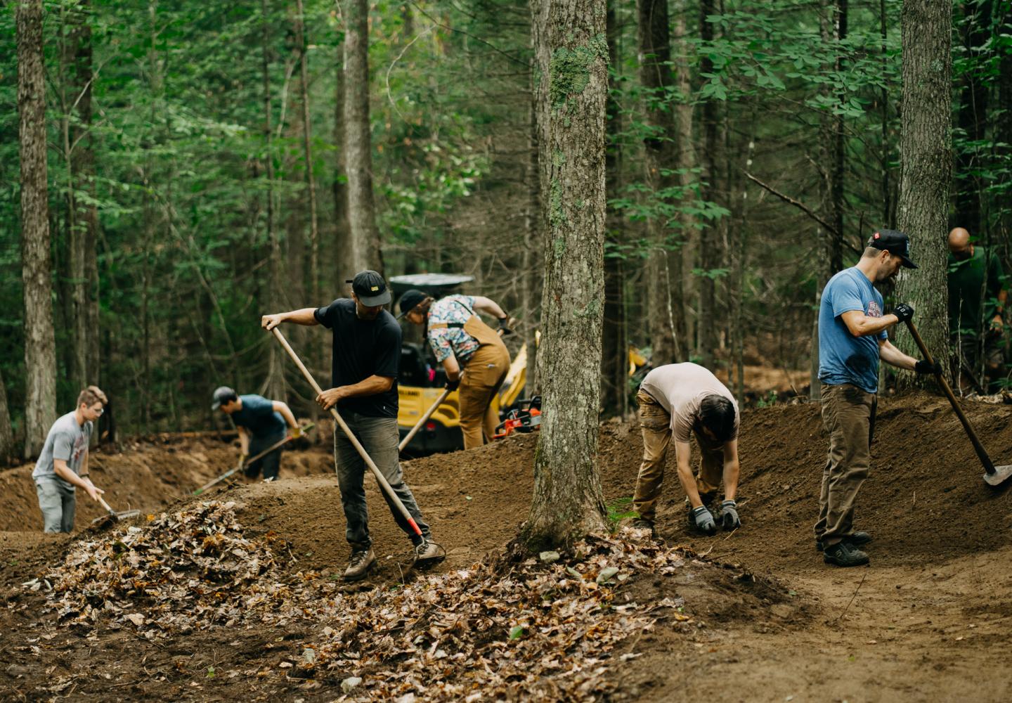 Members of the Barkeater Trails Alliance work on a new flow trail at Craig Wood in Lake Placid.