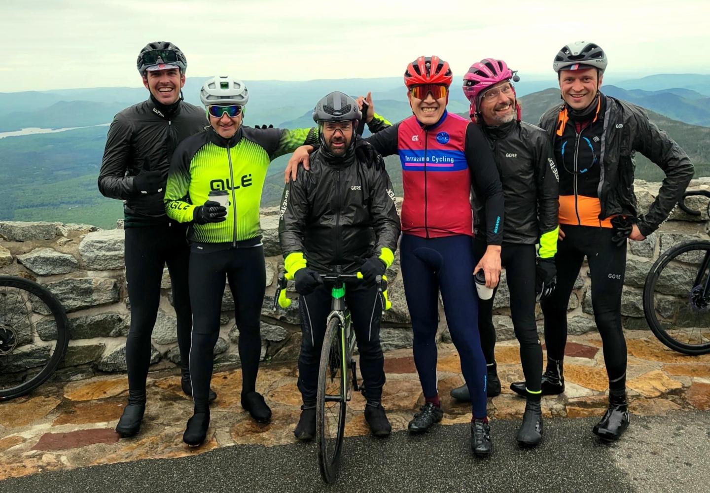 A group of cyclists celebrates the end of ADK Unite with a climb to the top of Whiteface Mountain.