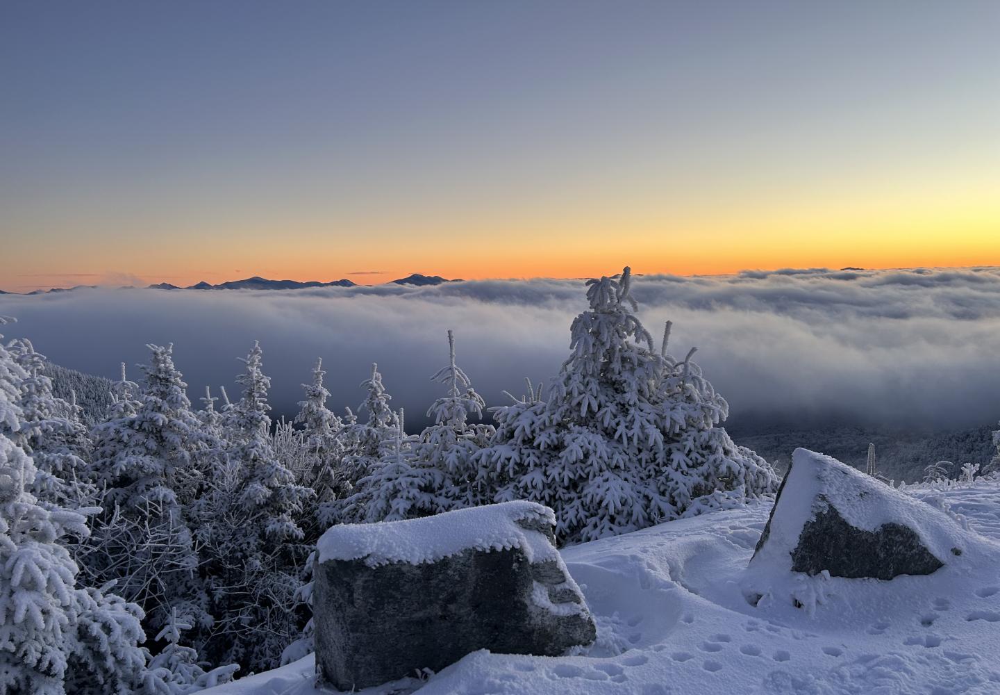 Low clouds make the Adirondack High Peaks look like islands in a sea of fluff.