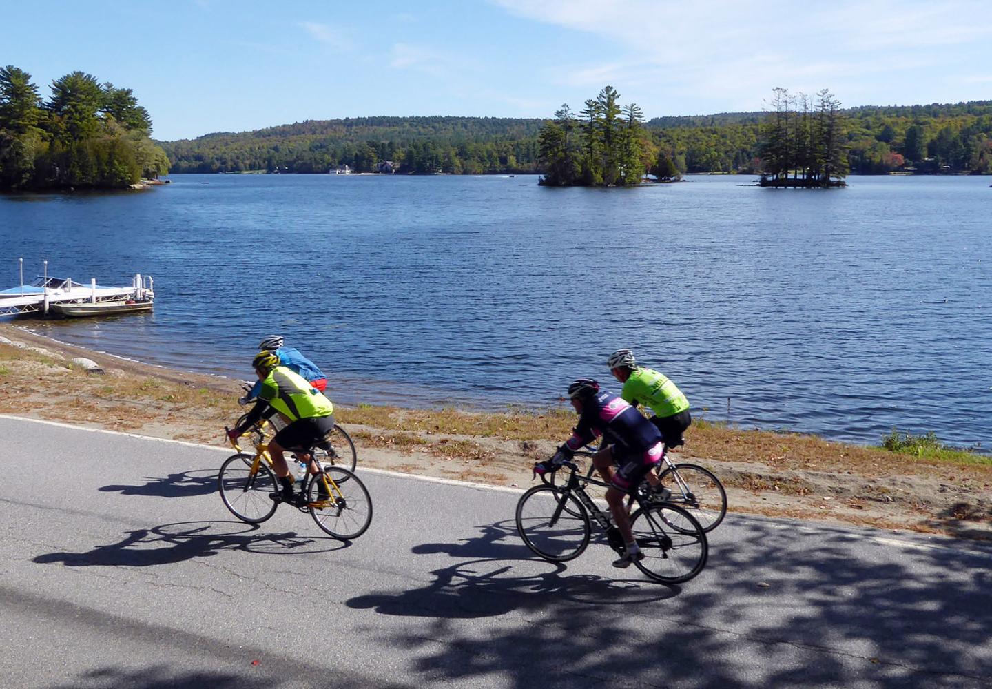 Cyclists enjoy the scenery around Brant Lake in the Schroon Lake Region.
