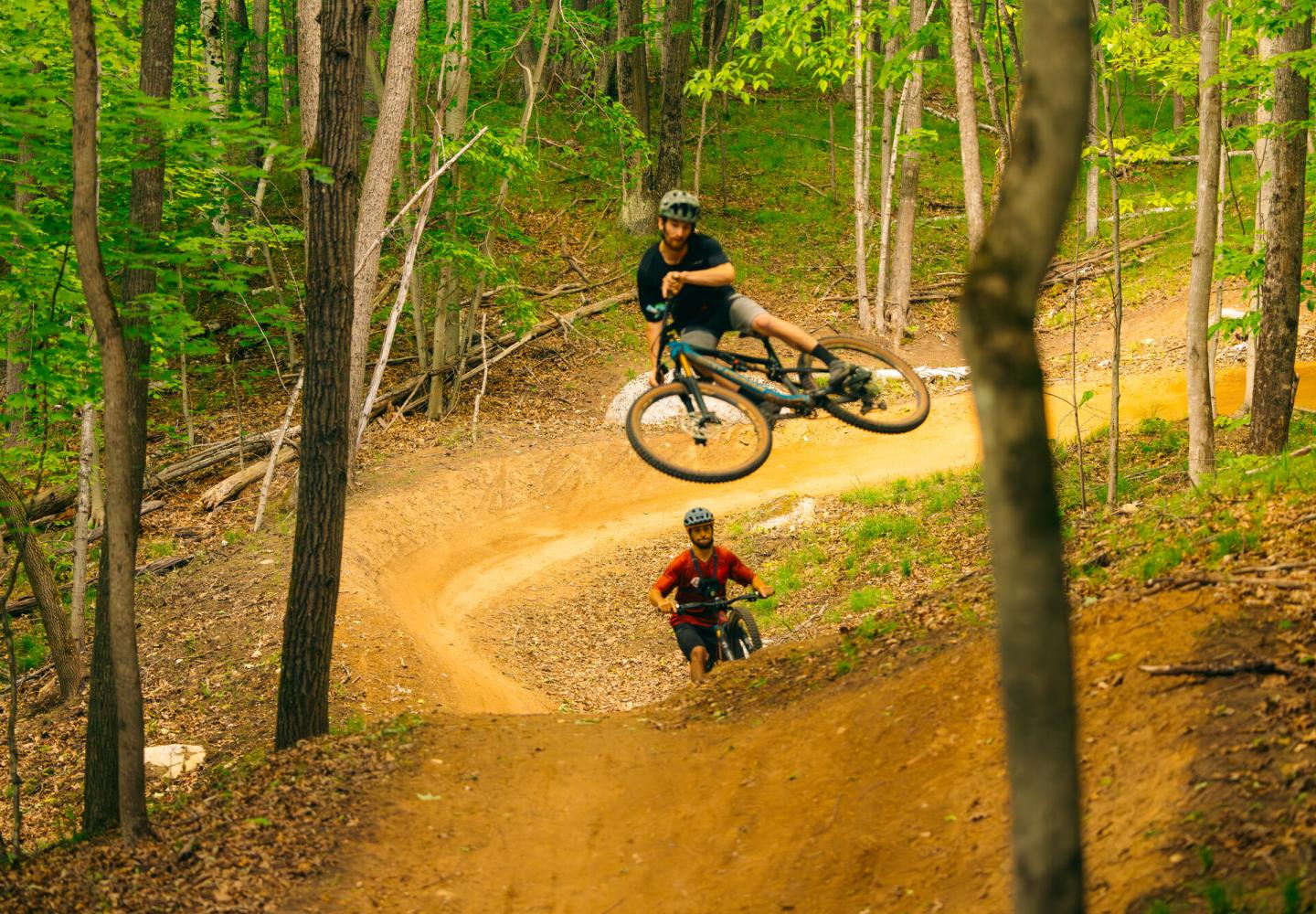 A mountain biker soars at the East Branch Community Trails in Keene, NY.