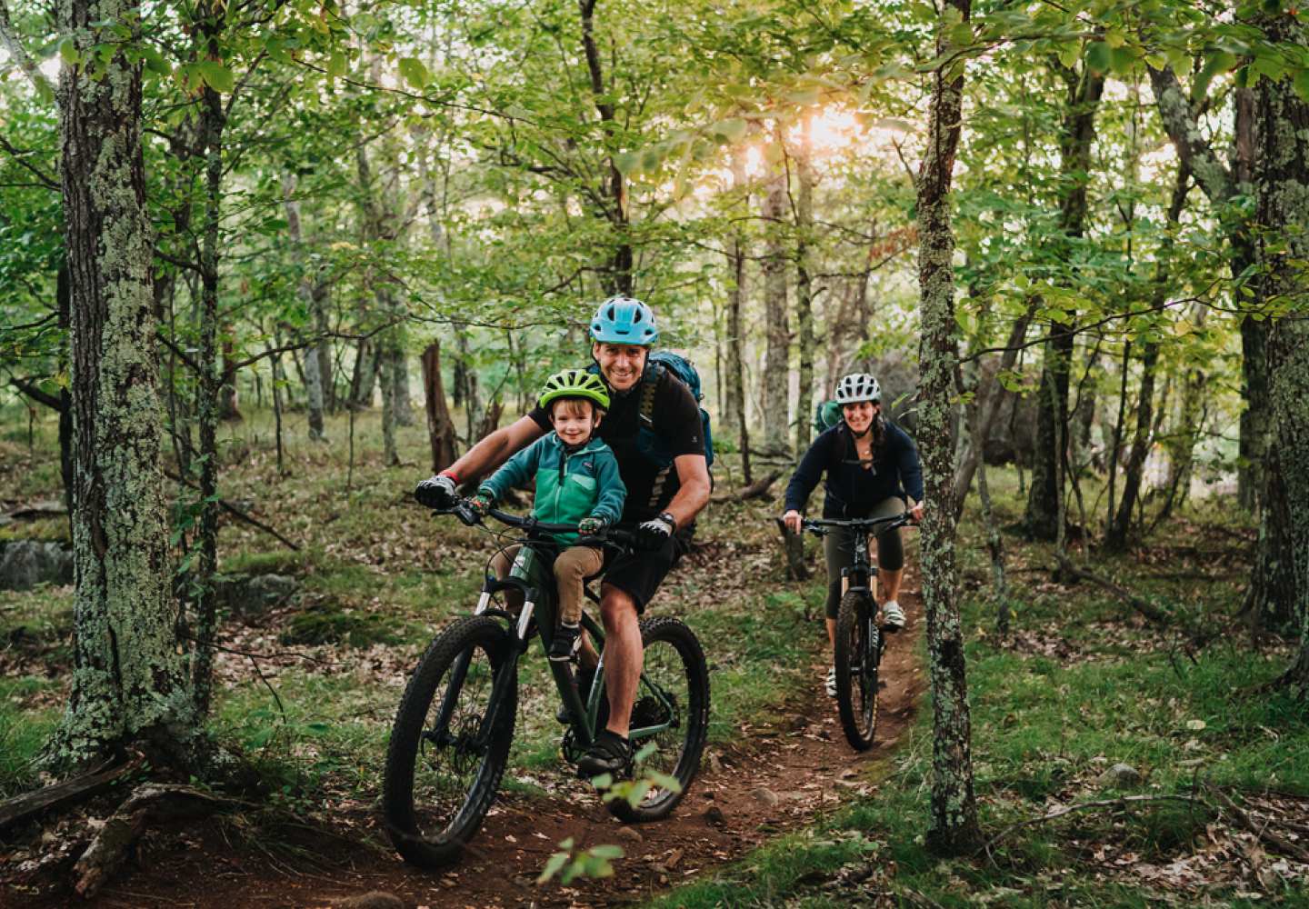 A family mountain bikes in the Barkeater Trails Alliance network.