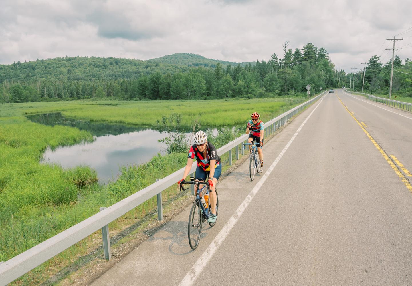 Cyclists pedal along the Saranac River during the Adirondack Women's Weekend.