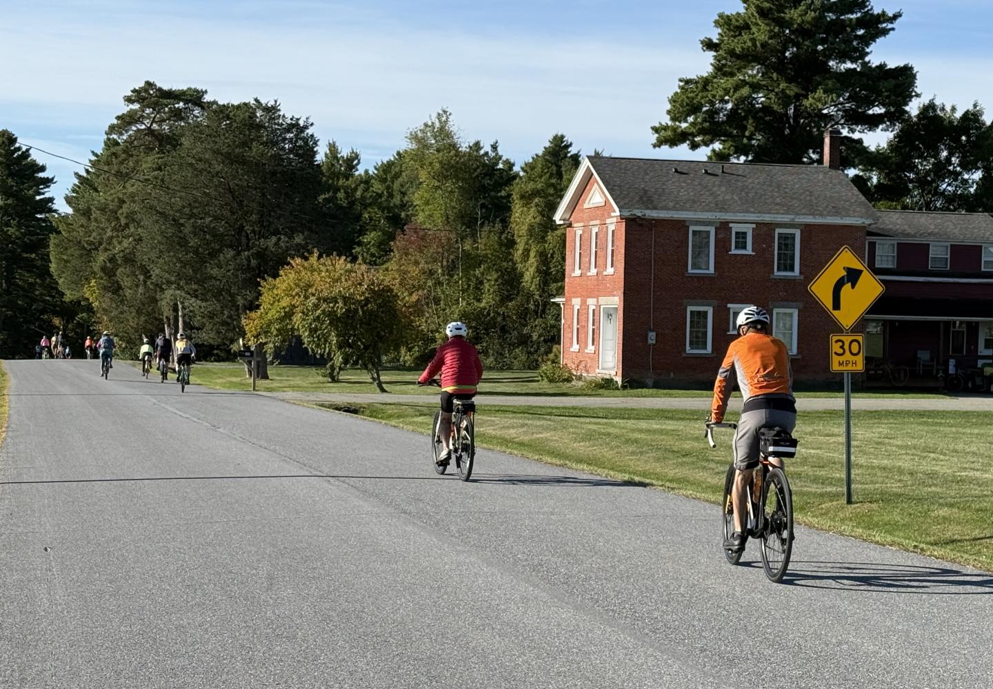 Cyclists travel on a rural road during Bike the Barns.