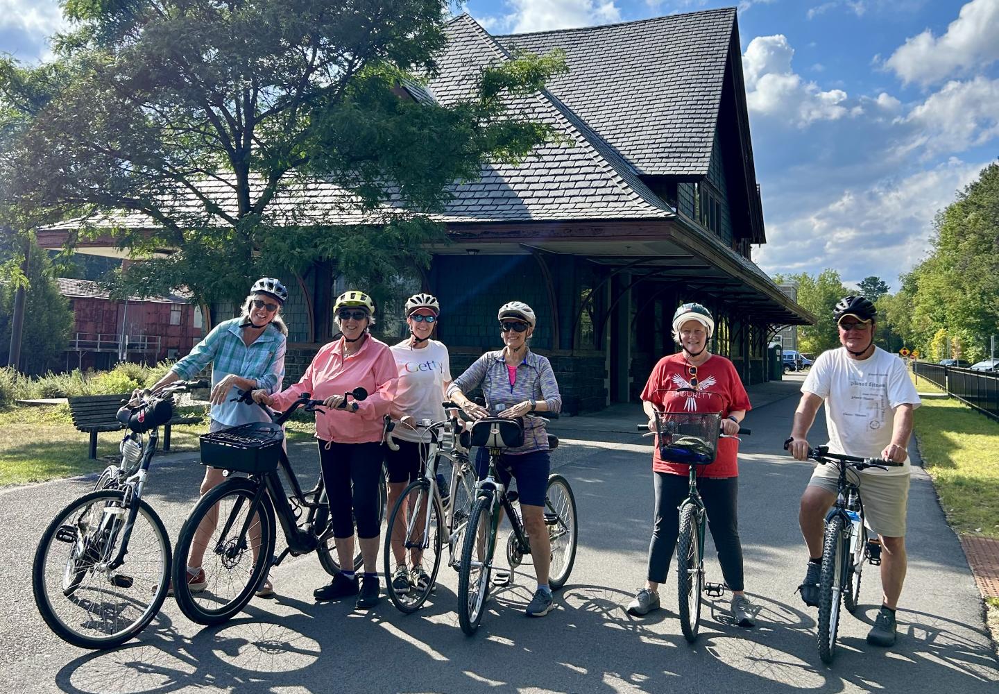 Cyclists pose in front of Saranac Lake's Union Depot during a guided tour hosted by Bike Adirondacks.