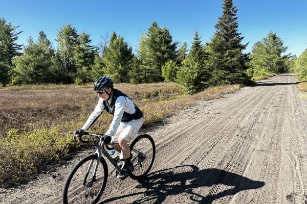 A cyclist rides toward Lake Clear on the former New York Central Railroad.