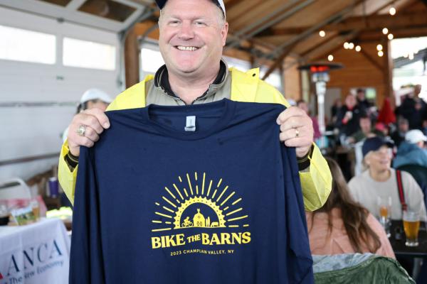 A rider shows off the 2023 Bike the Barns T-Shirt