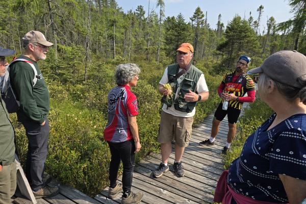 Naturalist Milt Adams leads a group interpretive hike at the Paul Smith's VIC.