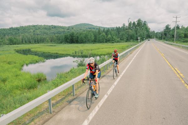 Cyclists pedal along the Saranac River during the Adirondack Women's Weekend. 